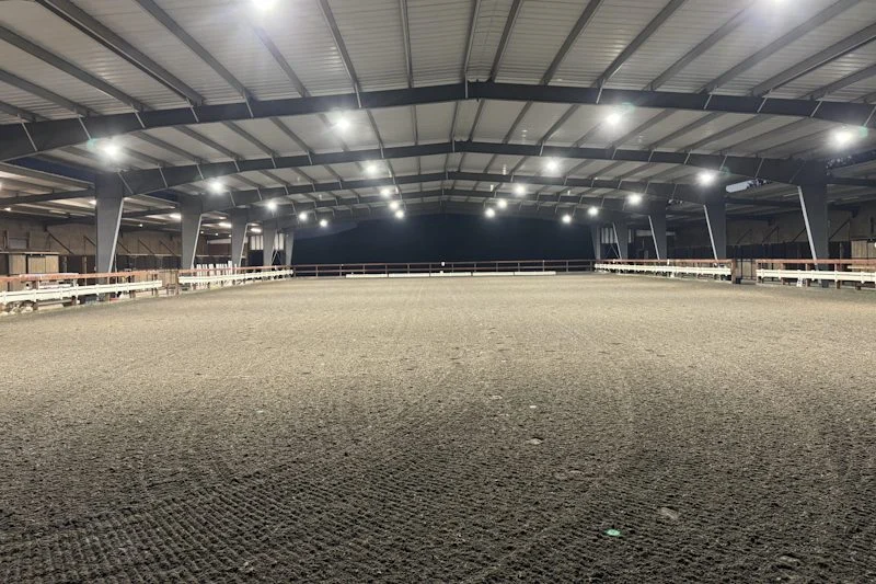 Inside the 100 by 200 foot covered arena with lights on