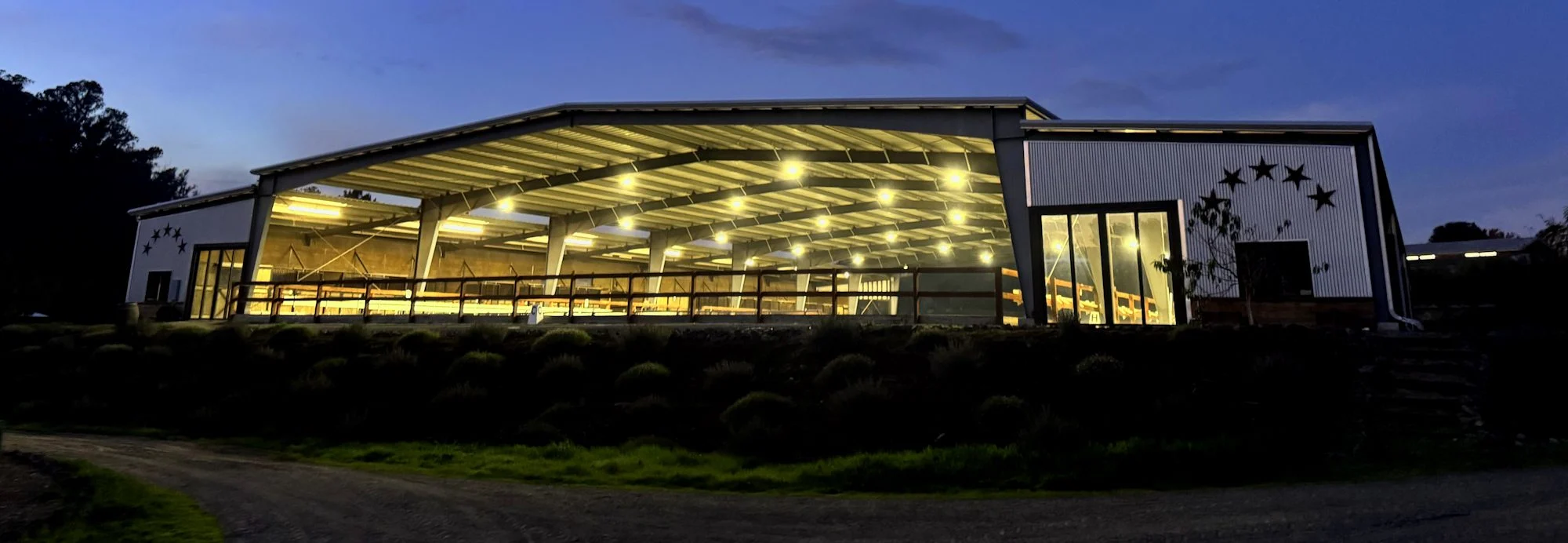 Jaz Creek covered riding arena lit at night