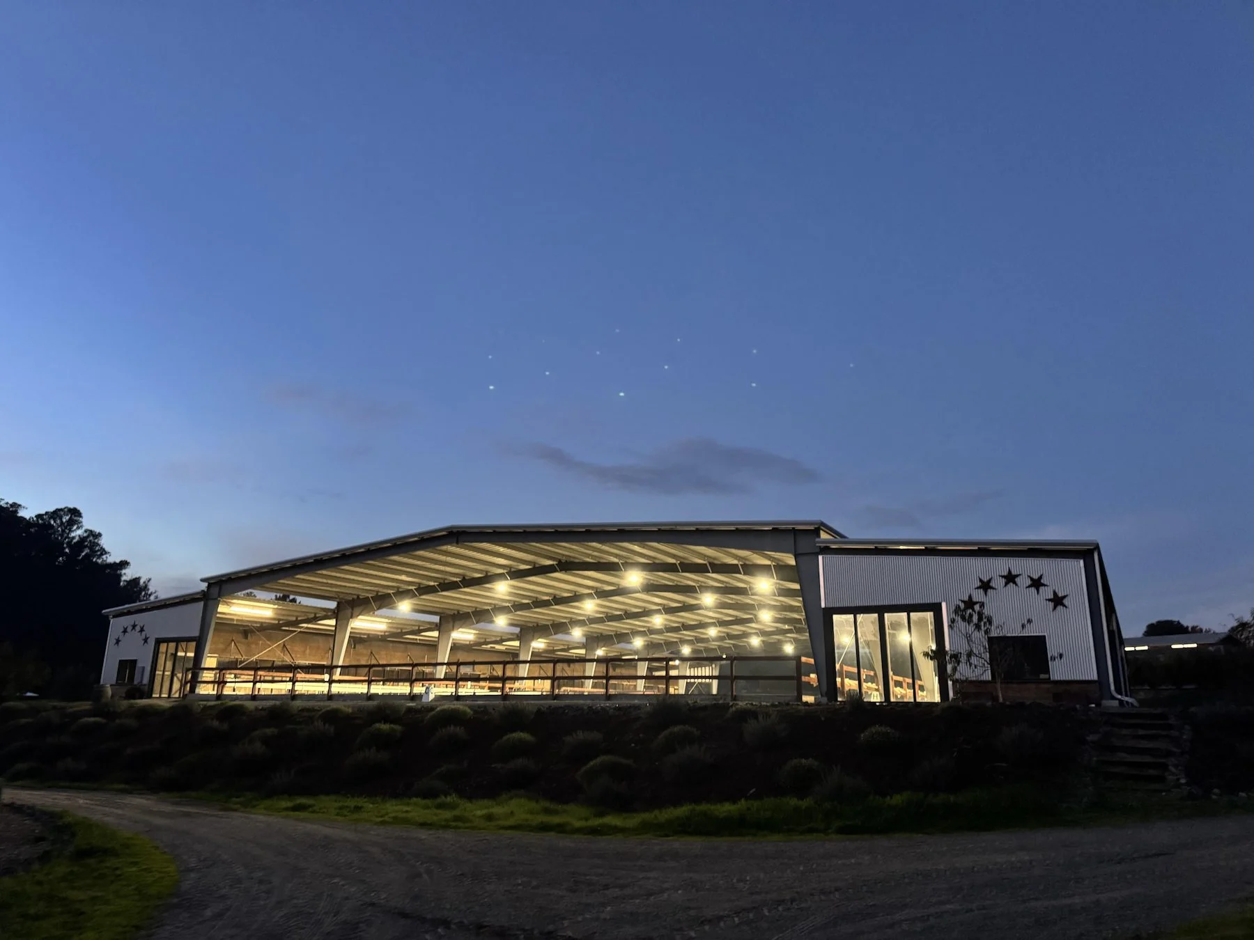 Jaz Creek covered arena and barn complex at dusk in Petaluma, California